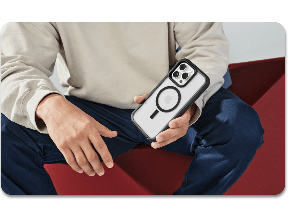 man holding an iPhone 16 with a clear and black case
